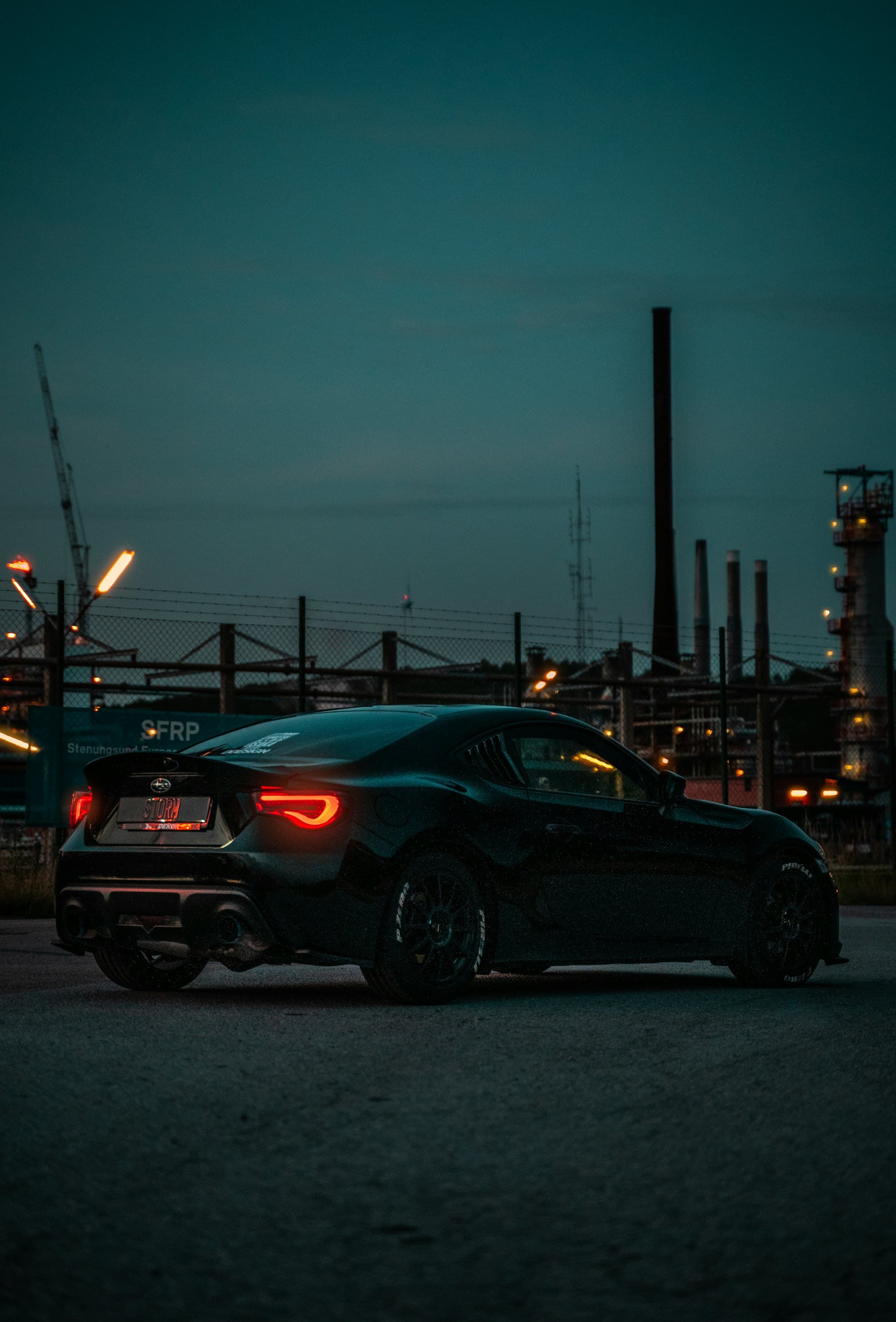 Black sedan with tinted windows at night
